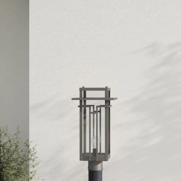The Boxwood post lantern combines timeless Mission-style architecture with contemporary clean lines. Its Antique Bronze finish and clear glass panels provide warm, welcoming illumination for outdoor pathways and entryways. - alternate view