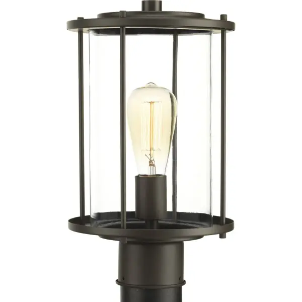 The Gunther Post Lantern combines timeless farmhouse styling with industrial accents in a durable Antique Bronze finish. Perfect for illuminating pathways, driveways, and outdoor living spaces with warm, welcoming light.