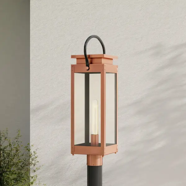 The Union Square post lantern combines transitional design with farmhouse warmth, featuring clear glass panels and an antique copper finish. Perfect for illuminating pathways, driveways, and outdoor living spaces with timeless style. - alternate view