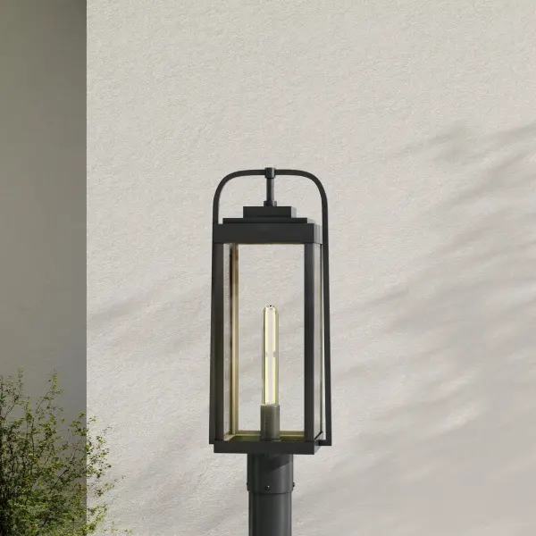 The Walcott post light combines modern farmhouse style with durable outdoor construction. Its clean black finish and clear glass shade provide welcoming illumination for pathways, driveways, and front entries. - alternate view