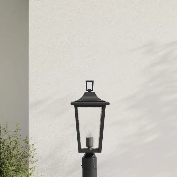 The Padgett post light combines traditional styling with durable outdoor construction. Clear seeded glass creates ambient lighting while the antique bronze finish adds warmth to exterior spaces.