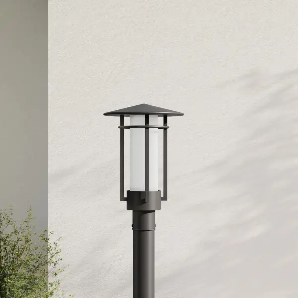 The Exton post lantern combines contemporary design with traditional outdoor lighting functionality. Its etched seeded glass creates ambient illumination while the black finish provides modern appeal for residential and commercial applications.