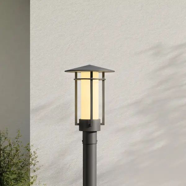 The Exton post lantern combines contemporary design with traditional outdoor lighting functionality. Its etched seeded glass creates ambient illumination while the black finish provides modern appeal for residential and commercial applications. - alternate view
