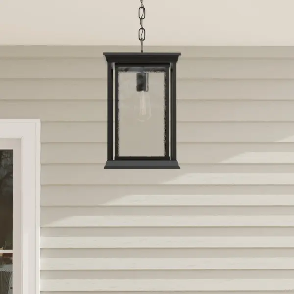 The Endicott hanging lantern blends modern clean lines with craftsman details in a durable outdoor-rated fixture. Its textured black finish and clear glass panels create sophisticated curb appeal while providing reliable illumination.