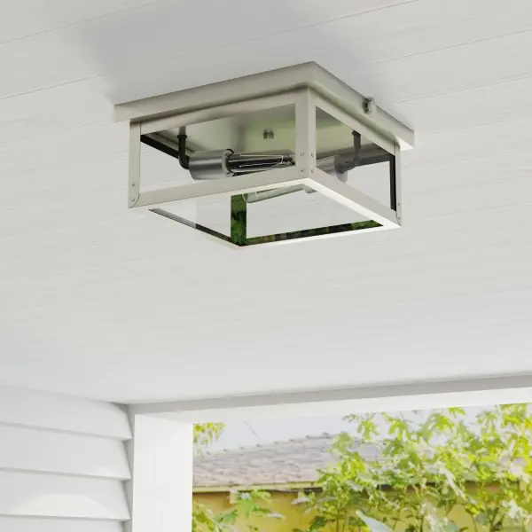 The Union Square flush mount combines urban industrial style with farmhouse charm in a durable stainless steel finish. Its two-light design provides ample illumination while maintaining a low profile, ideal for covered outdoor areas and transitional spaces.