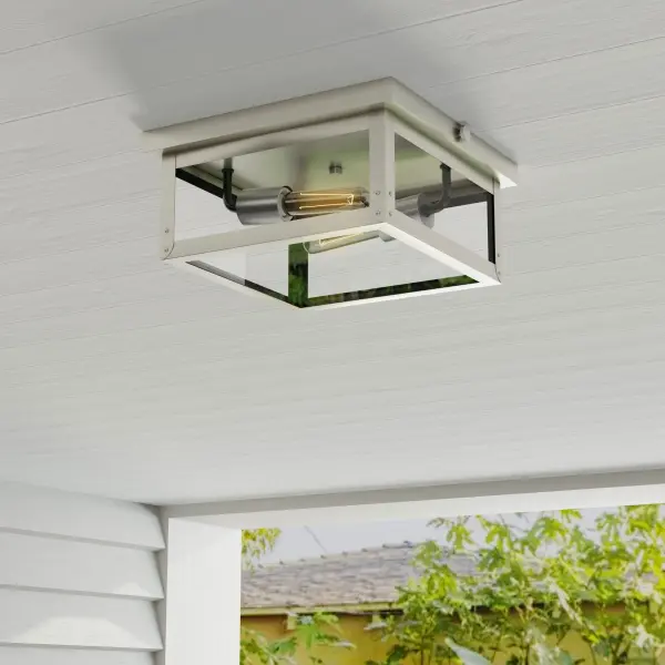 The Union Square flush mount combines urban industrial style with farmhouse charm in a durable stainless steel finish. Its two-light design provides ample illumination while maintaining a low profile, ideal for covered outdoor areas and transitional spaces. - alternate view