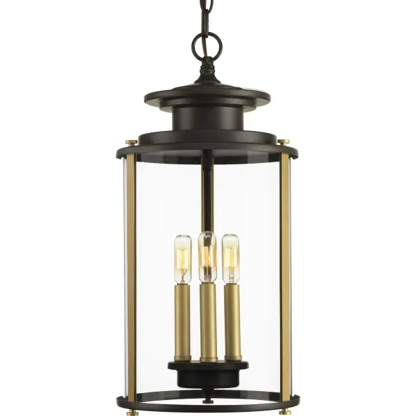The Squire three-light hanging lantern combines traditional design with durable outdoor construction. Its antique bronze finish and clear glass panels create warm, welcoming illumination for covered outdoor spaces. - alternate view