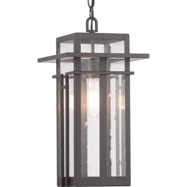 The Boxwood hanging lantern blends clean modern lines with craftsman detailing in a durable outdoor fixture. Its antique bronze finish and clear glass panels provide warm illumination for covered outdoor spaces.