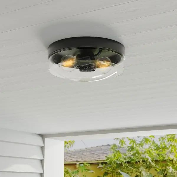 The Weldon flush mount combines farmhouse charm with transitional versatility, making it ideal for porches, patios, and interior spaces. Its compact two-light design and JA8 compliance ensure energy efficiency. - alternate view