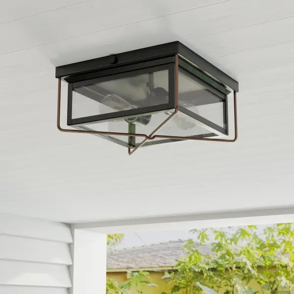 The Barlowe flush mount combines clear seeded glass with antique bronze finish for a transitional look that works indoors and out. Perfect for low-ceiling spaces needing character without sacrificing headroom.