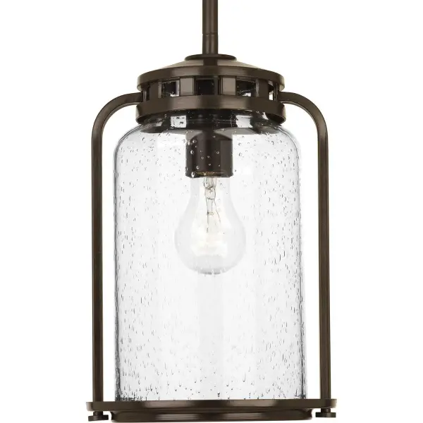 The Botta hanging lantern combines timeless design with durable outdoor construction. Its antique bronze finish and clear glass panels create welcoming illumination for porches, patios, and entryways.