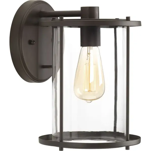 The Gunther Large Wall Lantern combines rustic farmhouse aesthetics with industrial durability. Its antique bronze finish and clear glass panels create welcoming illumination for outdoor spaces while meeting JA8 energy standards. - alternate view