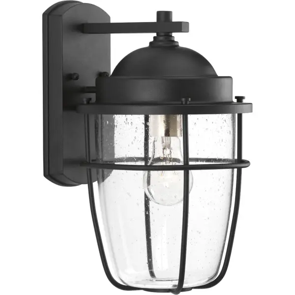The Holcombe Medium Wall Lantern blends transitional elegance with farmhouse warmth, featuring a durable black finish and clear glass panels. Perfect for outdoor spaces, this JA8-compliant fixture adds welcoming illumination to porches, patios, and entryways with timeless style.