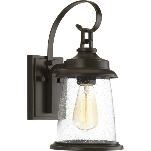The Conover Small Wall Lantern blends traditional lantern styling with transitional elegance, featuring an antique bronze finish and clear glass panels. Perfect for outdoor entryways and porches seeking timeless curb appeal. - alternate view