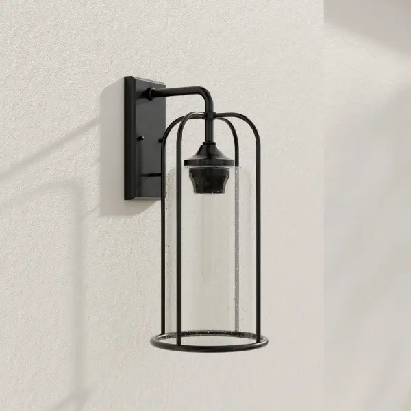 The Watch Hill wall lantern combines timeless farmhouse styling with clear seeded glass and a durable black finish. Perfect for creating welcoming outdoor spaces with its large-scale presence and warm ambient lighting.