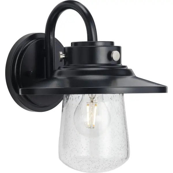 The Tremont wall lantern combines timeless farmhouse style with contemporary functionality. Clear seeded glass creates beautiful light patterns while the black finish adds bold contrast to any exterior. - alternate view