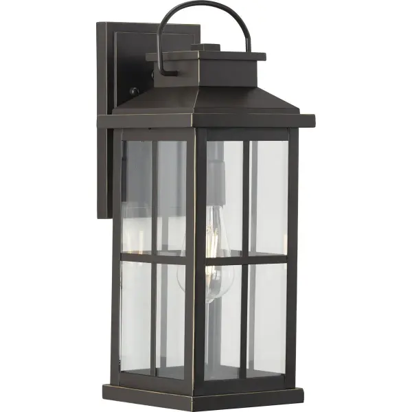 The Williamston wall lantern combines timeless farmhouse styling with clear glass panels and antique bronze finish. Its large scale makes a bold statement on exterior walls while providing ample illumination for entryways and outdoor living spaces. - alternate view