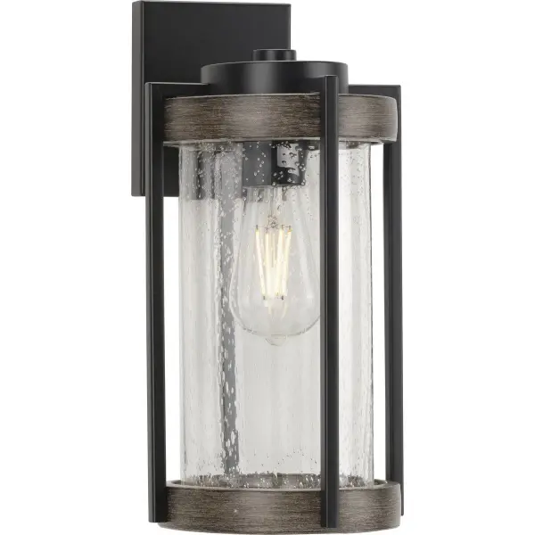The Whitmire wall lantern combines rustic farmhouse styling with practical outdoor performance. Its matte black finish and clear seeded glass create timeless curb appeal while JA8 compliance ensures energy efficiency.