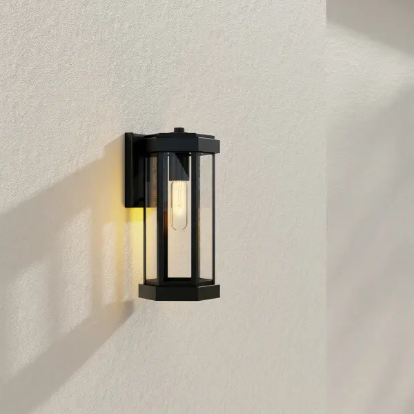 The Ramsey Small Wall Lantern blends transitional design with modern farmhouse elements, featuring a clean black finish and clear glass panels. JA8 compliant for California energy standards, this compact fixture delivers style and efficiency for residential outdoor spaces. - alternate view