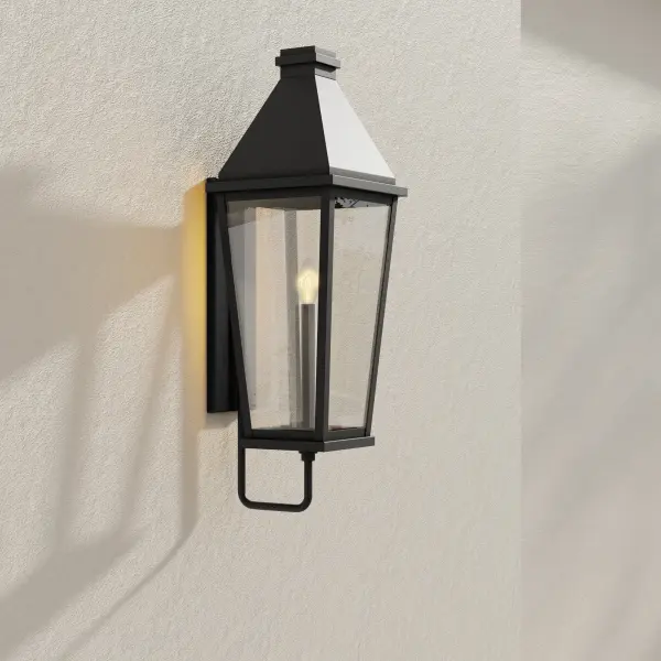 The Richmond Hill wall lantern combines clean modern lines with farmhouse charm in a large-scale design. Clear glass panels showcase the light source while black finish provides bold contrast against exterior walls. - alternate view
