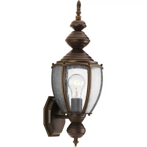 The Roman Coach wall lantern brings traditional elegance to outdoor spaces with its antique bronze finish and clear seeded glass. At 19.25" tall, it provides substantial presence while maintaining classic proportions.