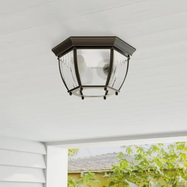 The Roman Coach flush mount brings timeless elegance to outdoor spaces with its antique bronze finish and traditional lantern styling. Perfect for porches and patios, this compact fixture delivers reliable illumination.