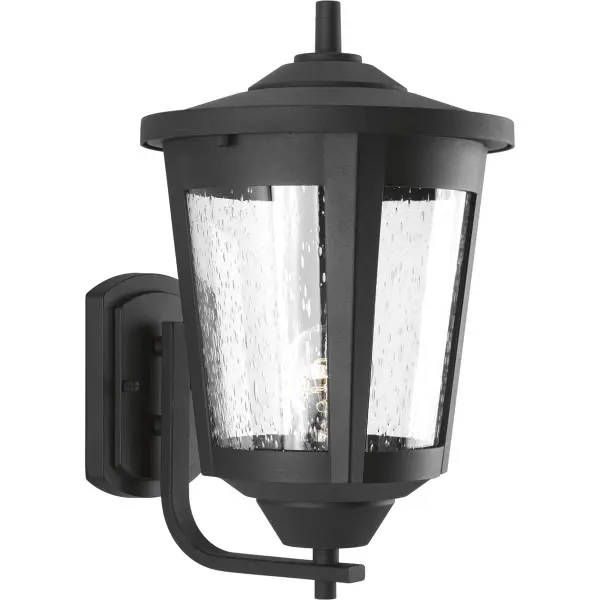 The East Haven wall lantern combines traditional lantern styling with transitional simplicity. Its textured black finish and clear glass panels provide reliable outdoor illumination with enduring curb appeal.