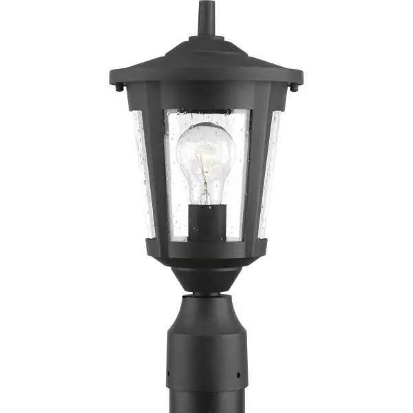 The East Haven post lantern combines traditional charm with transitional versatility. Its antique bronze finish and clear glass panels provide warm, welcoming illumination for outdoor pathways and entryways.