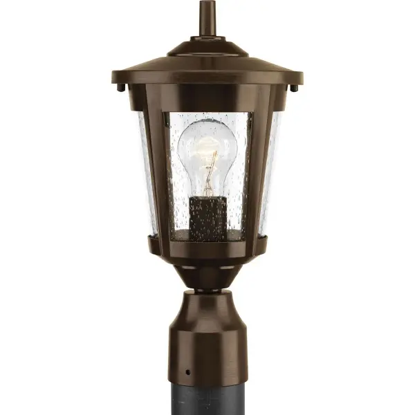 The East Haven post lantern combines traditional charm with transitional versatility. Its antique bronze finish and clear glass panels provide warm, welcoming illumination for outdoor pathways and entryways. - alternate view