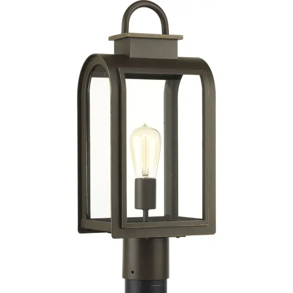 The Refuge Collection post lantern combines timeless design with outdoor durability. Its Oil Rubbed Bronze finish and clear glass panels create welcoming illumination for pathways, patios, and entryways.