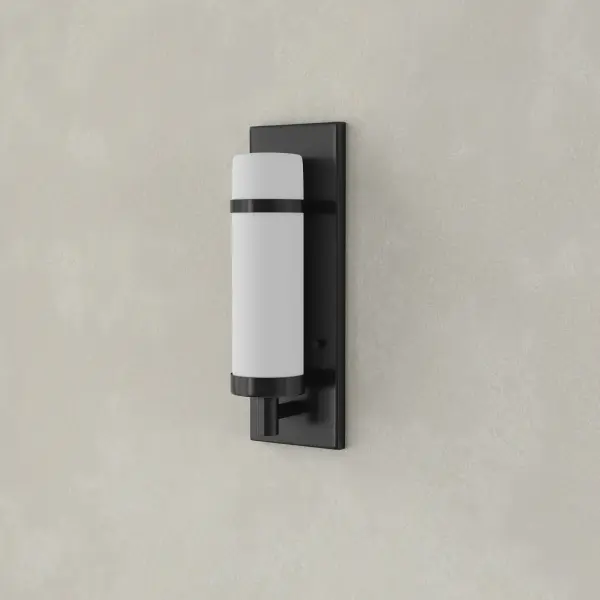 The Hartwick wall sconce combines clean lines with sophisticated styling, featuring a brushed nickel finish and glass shade. Perfect for bathrooms, hallways, and dining spaces where refined lighting is essential.
