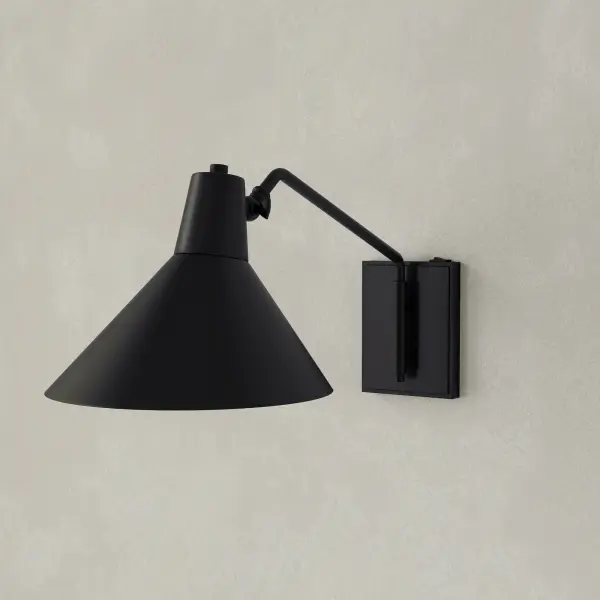The Trimble wall bracket combines mid-century modern elegance with industrial styling in a brushed bronze finish. Perfect for adding ambient lighting to hallways, bedrooms, and dining spaces with its refined aesthetic.