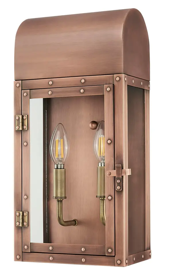 The Spencer 2-Light Wall Sconce combines traditional craftsmanship with durable copper construction. Its copper patina finish develops character over time while clear glass panels provide warm, welcoming illumination for outdoor spaces.