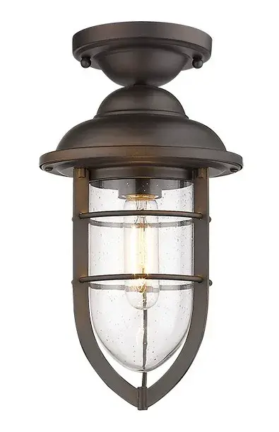 The Dylan convertible mini-pendant combines industrial-inspired seeded glass with oil-rubbed bronze finish for timeless outdoor appeal. Its compact 7.5-inch width and convertible design make it ideal for porches, patios, and covered entryways. - alternate view
