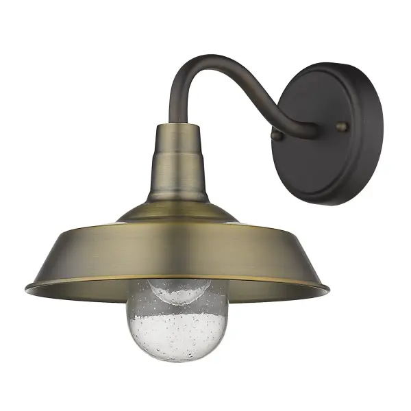 The Burry wall sconce combines rustic charm with industrial durability. Its antique bronze finish and clear seeded glass globe create warm, inviting illumination perfect for outdoor entryways and porches.