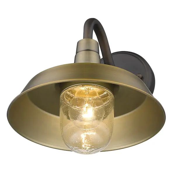 The Burry wall sconce combines rustic charm with industrial durability. Its antique bronze finish and clear seeded glass globe create warm, inviting illumination perfect for outdoor entryways and porches. - alternate view