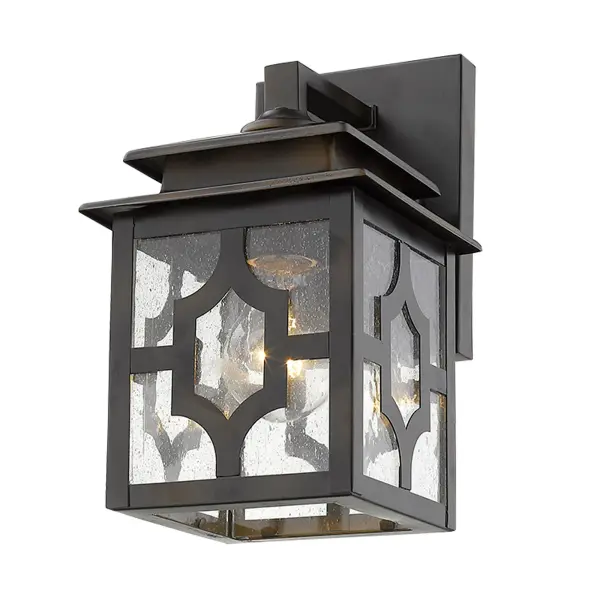 The Calvert wall sconce combines traditional styling with durable steel construction and charming seeded glass. Its compact 10-inch height and oil-rubbed bronze finish make it ideal for flanking doors or illuminating outdoor spaces. - alternate view