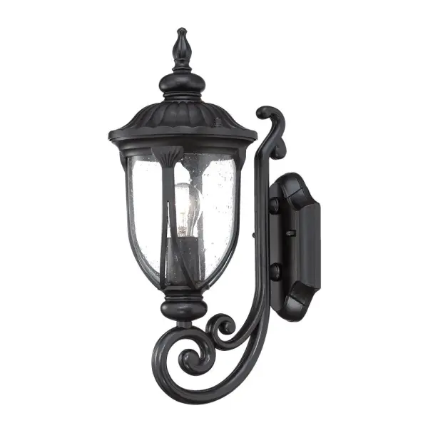 The Laurens wall sconce combines durable cast aluminum construction with charming seeded glass for a timeless outdoor lighting solution. Its matte black finish and transitional design complement various architectural styles.