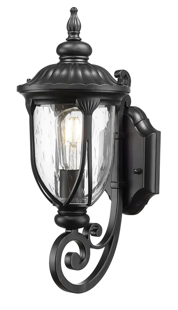 The Laurens wall sconce combines durable cast aluminum construction with charming seeded glass for a timeless outdoor lighting solution. Its matte black finish and transitional design complement various architectural styles. - alternate view