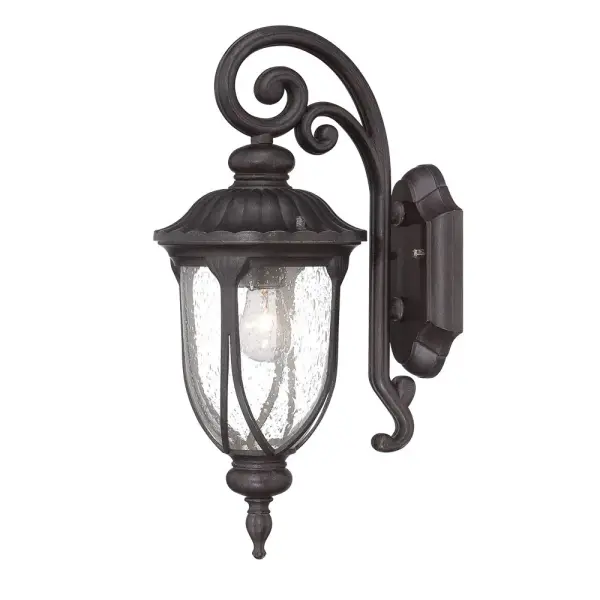 The Laurens wall sconce combines traditional styling with weather-resistant cast aluminum construction. Its clear seeded glass shade creates ambient lighting perfect for outdoor entryways and patios.