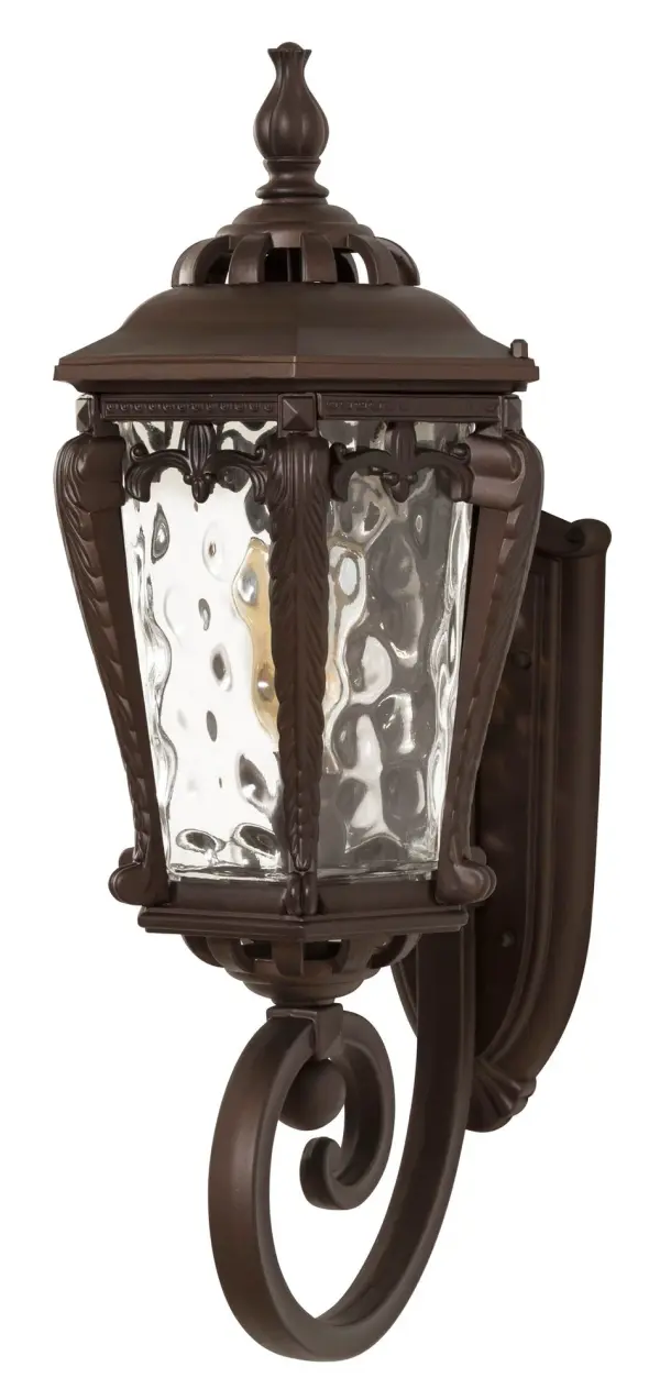 The Stratford wall sconce combines traditional design with weather-resistant cast aluminum and distinctive hammered water glass. At 23 inches tall, it provides substantial illumination for outdoor spaces with timeless appeal.
