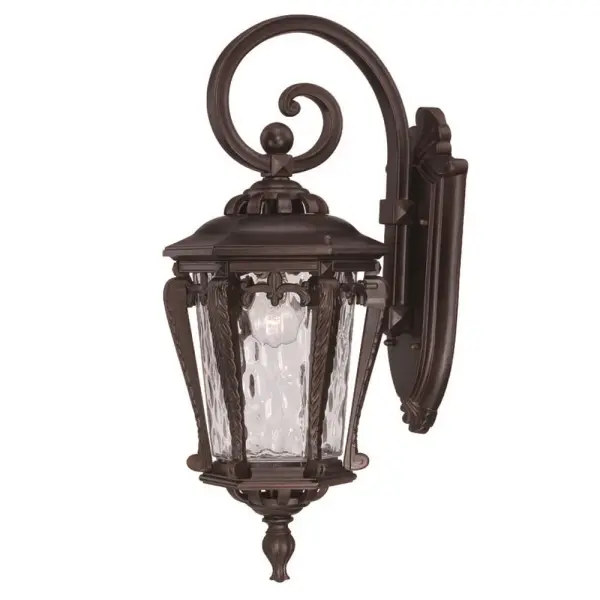 The Stratford wall sconce combines traditional styling with weather-resistant cast aluminum and distinctive hammered water glass. At 23 inches tall, it provides substantial presence for outdoor entryways and patios.