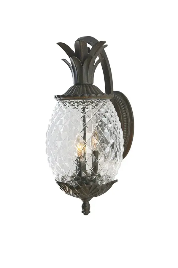 The Lanai 3-Light Wall Sconce brings coastal charm to outdoor spaces with its cast aluminum construction and unique pineapple-cut glass globes. The Black Coral finish offers durability and style for entryways and patios. - alternate view