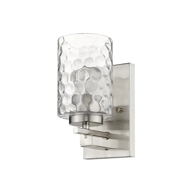 The Livvy sconce combines classic styling with contemporary finishes, featuring hand-blown clear optic glass and a refined satin nickel finish. Its compact 9.5" height makes it ideal for bathroom vanities and hallways.
