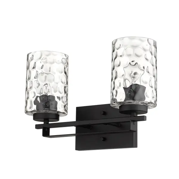 The Livvy 2-Light Vanity combines matte black steel construction with hand-blown clear optic glass for a sophisticated industrial aesthetic. Its compact 15-inch width makes it ideal for smaller vanities while providing ample illumination.