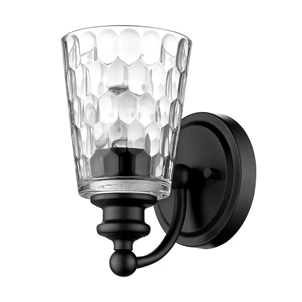 The Mae sconce combines industrial-inspired matte black steel with artisanal hand-blown clear optic glass for a sophisticated look. Compact at 8.5" high, it's ideal for vanity lighting or accent illumination in modern spaces.