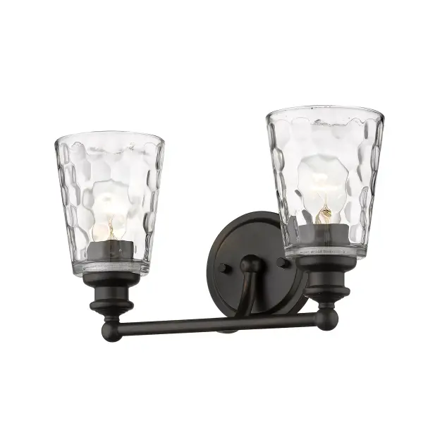 The Mae 2-Light Sconce combines industrial charm with transitional elegance. Featuring hand-blown clear optic glass and oil-rubbed bronze finish, this compact fixture delivers ample illumination for vanity areas while adding sophisticated style. - alternate view