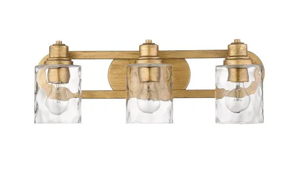 The Lumley bath sconce combines antique gold finish with hand-blown clear optic glass for sophisticated bathroom lighting. Its 22-inch width provides ample illumination for vanity areas while the transitional design complements both traditional and contemporary spaces.