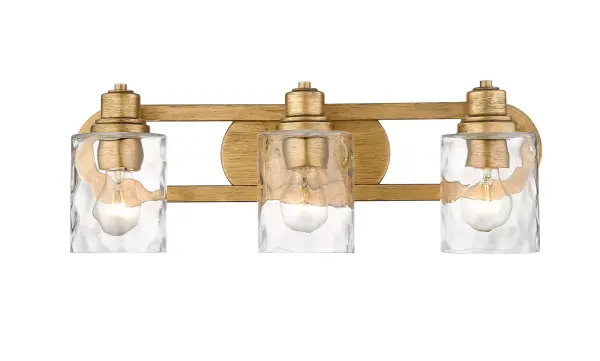 The Lumley bath sconce combines antique gold finish with hand-blown clear optic glass for sophisticated bathroom lighting. Its 22-inch width provides ample illumination for vanity areas while the transitional design complements both traditional and contemporary spaces. - alternate view