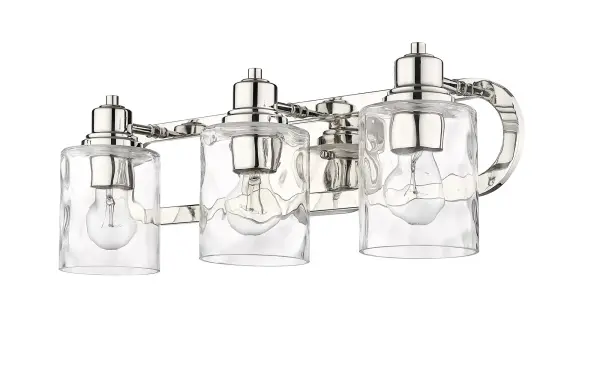 The Lumley 3-Light Bath Sconce combines timeless design with quality craftsmanship. Featuring hand-blown clear optic glass shades and polished nickel finish, this 22-inch fixture provides excellent task lighting for bathrooms.